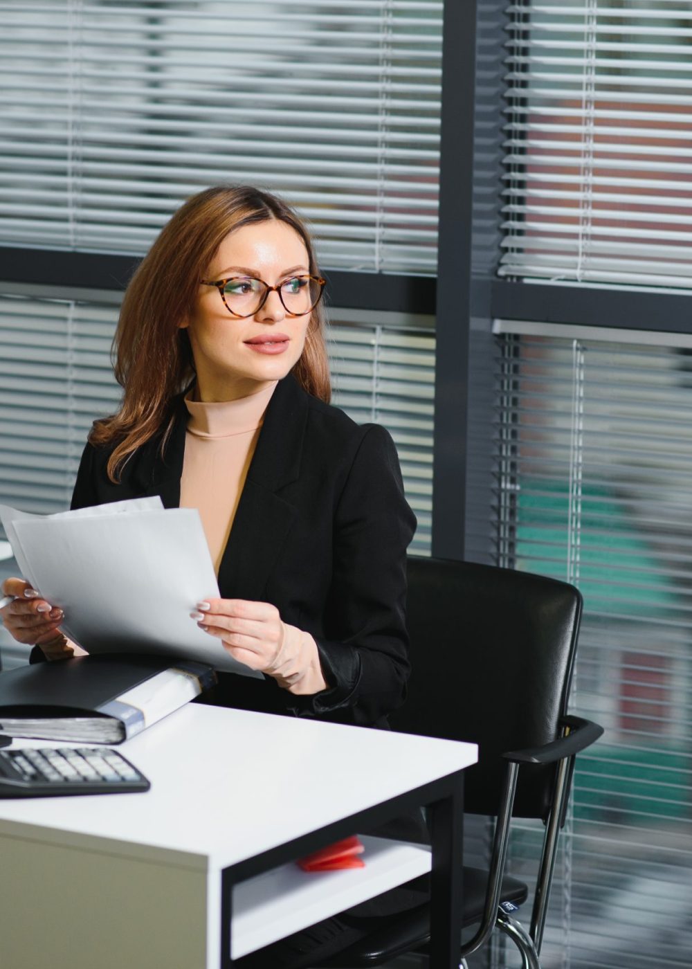 young businesswoman sitting at workplace and readi 2023 12 15 20 43 46 utc scaled